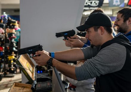 Group of men engaged in an indoor shooting game in Zagreb, showcasing hobby and leisure.
