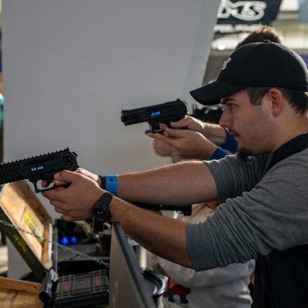 Group of men engaged in an indoor shooting game in Zagreb, showcasing hobby and leisure.