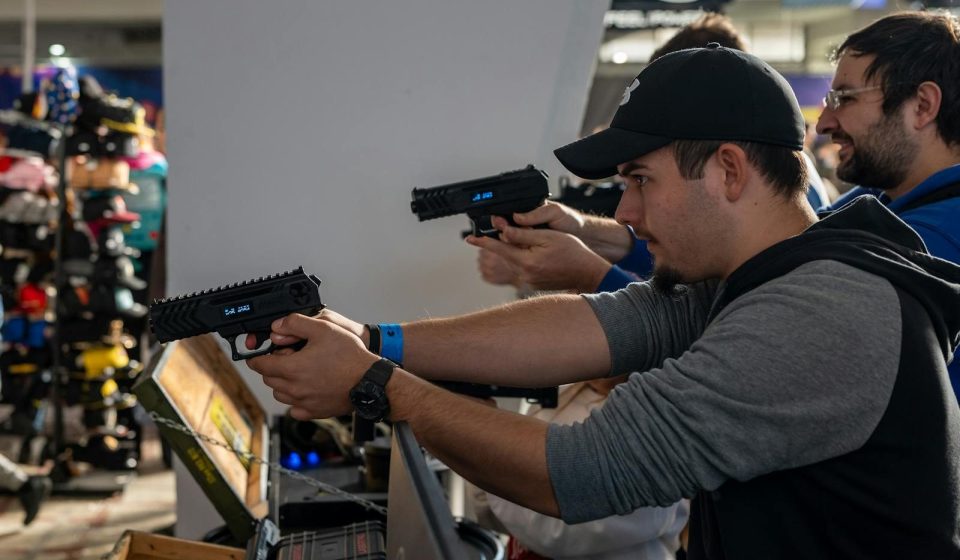 Group of men engaged in an indoor shooting game in Zagreb, showcasing hobby and leisure.