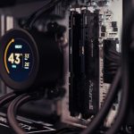 Detailed view of a gaming PC's interior featuring RAM and a digital CPU cooler display.