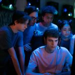 Group of diverse teenagers gaming together indoors, intense and focused.