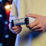 Hands gripping a game controller, displaying focus during an intense gaming session.