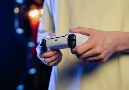 Hands gripping a game controller, displaying focus during an intense gaming session.