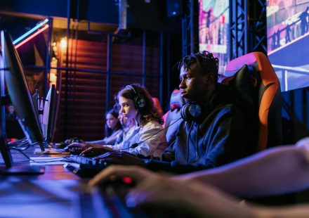 Serious gamers engage in a competitive esports event, highlighting focus and teamwork.