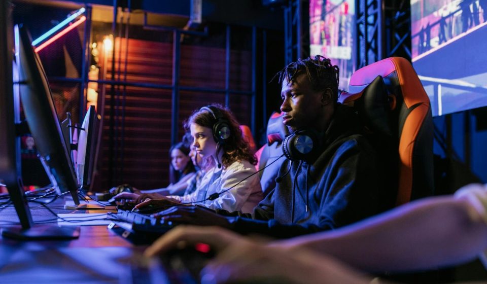 Serious gamers engage in a competitive esports event, highlighting focus and teamwork.