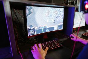 Engaging in an online gaming session with a modern setup, highlighting technology and recreation.