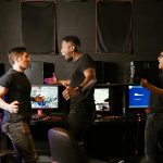 Enthusiastic group of diverse friends celebrating a gaming victory in an esports setting.
