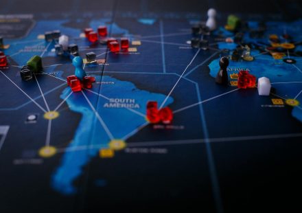 A strategic board game featuring a world map and colorful playing pieces.