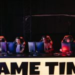 A group of diverse gamers participating in an online eSports tournament indoors.